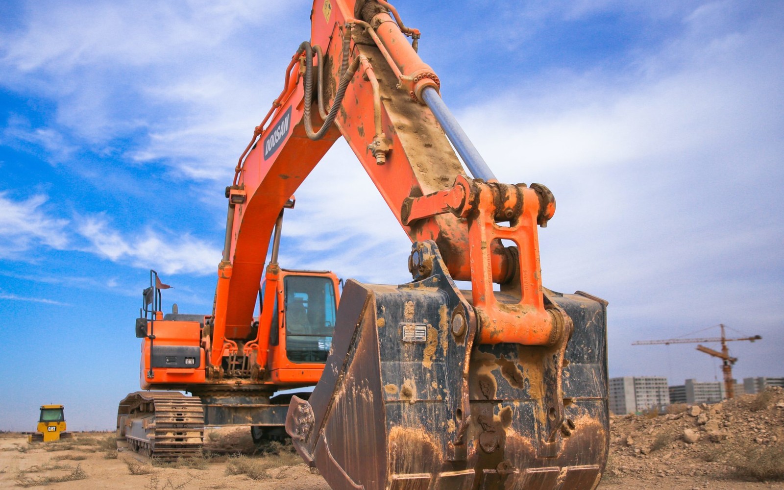  excavator and haulers on a jobsite eligible for  financing offers on heavy equipment loans, leases and low rates.